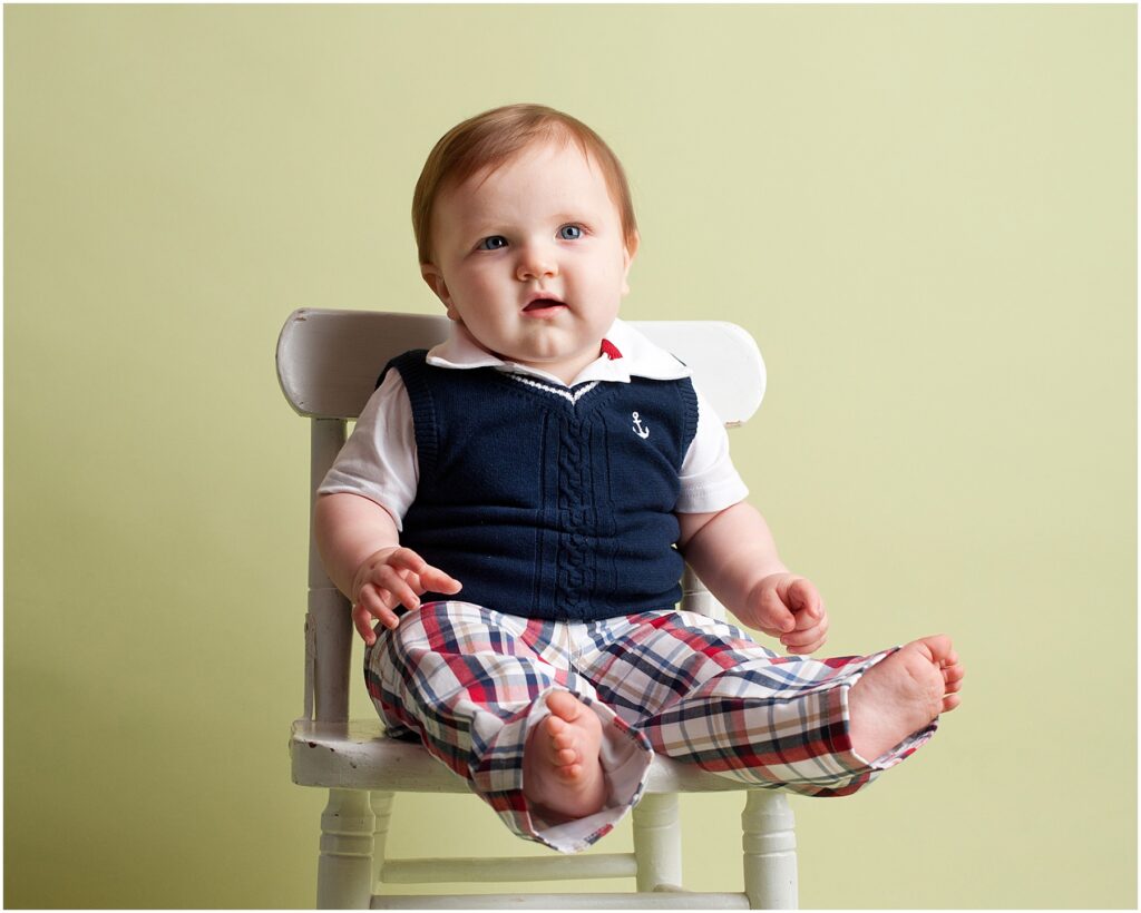 preppy toddler boy on green backdrop