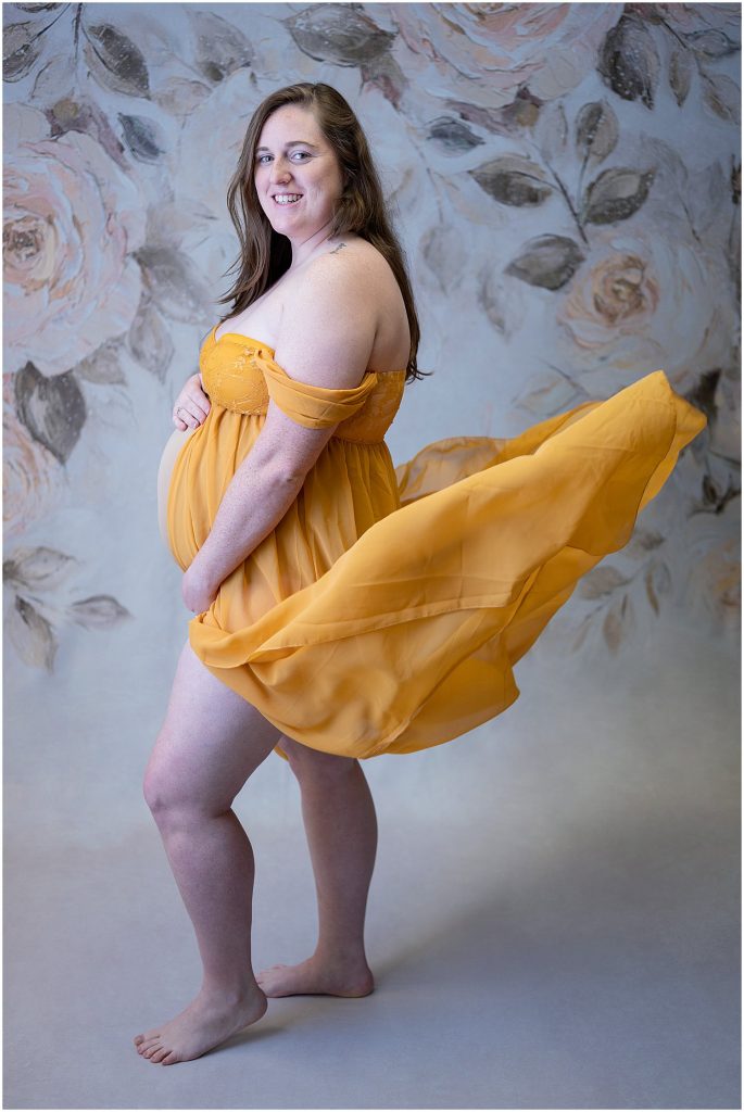 yellow flower backdrop maternity gown session