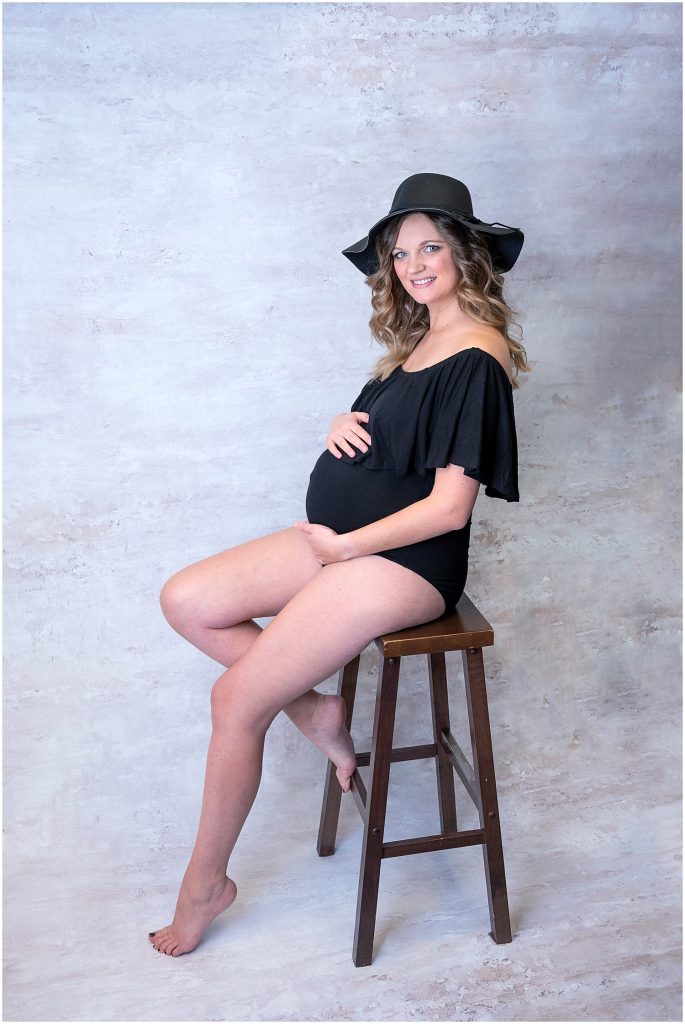 black hat and ruffle bodysuit maternity