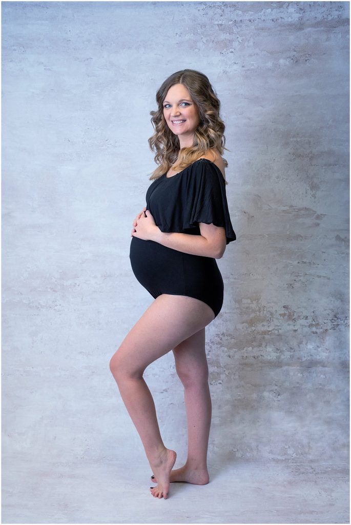 black hat and ruffle bodysuit maternity