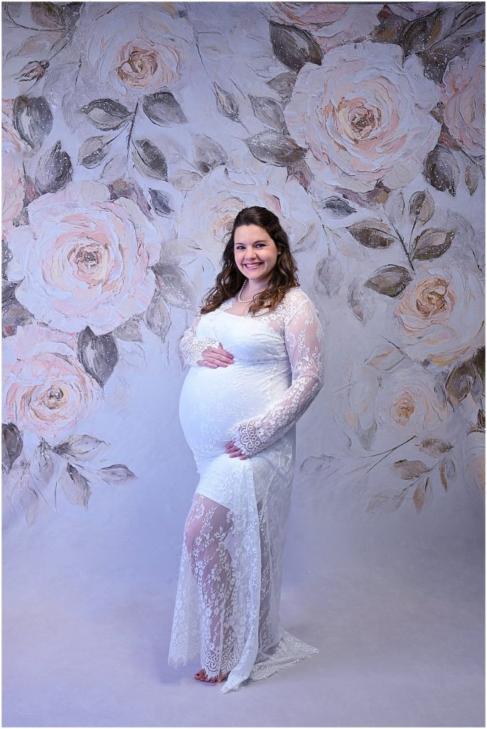 white lace maternity gown studio portrait