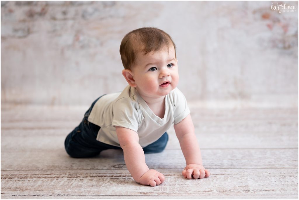 baby learning to crawl brick backdrop