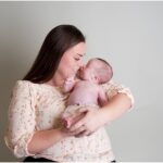 mom holding newborn daughter