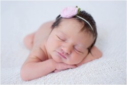 smiling newborn with pink headband