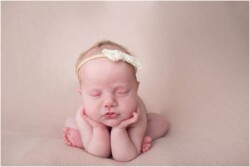 froggy pose on pink blanket