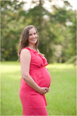 mom to be wearing coral ruffle dress