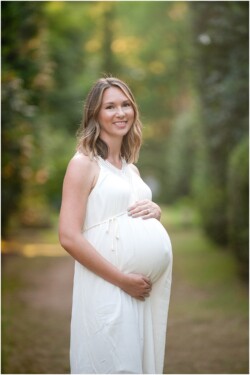 mom to be wearing white maternity dress