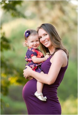 toddler sitting on moms pregnant belly