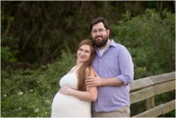 mom to be leaning on dad outside