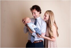 mom and dad holding baby