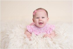 baby girl pushing up on flokati rug