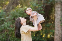 mom holding baby up in the air