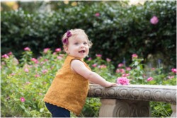 baby girl pulling up to stand using bench
