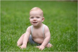 baby boy in suspenders outside