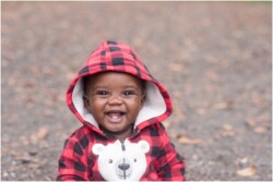 red buffalo plaid outfit on smiling boy