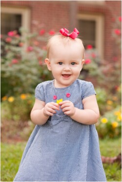 one year old holding flower