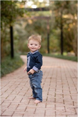 one year old boy on brick pavers
