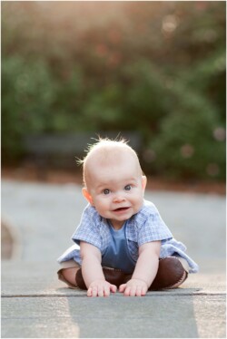 baby learning how to sit on bridge