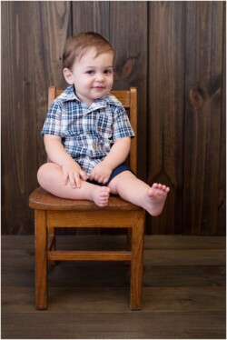 smiling baby in wooden chair