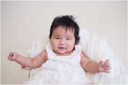 smiling baby in white prop