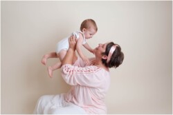 mother lifting baby in arms