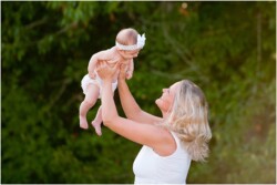 mom lifting baby in air