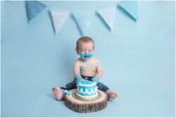 baby boy blue icing on face cake smash