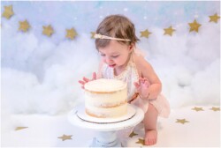 baby ready to eat her first birthday cake
