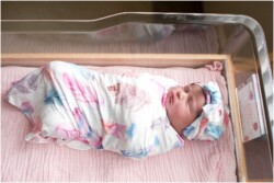 newborn girl in hospital with swaddle set