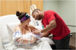 parents holding baby after birth