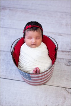 baby girl in american flag bucket prop