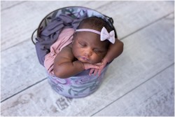 newborn baby girl in purple floral bucket