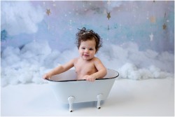 baby girl in bathtub after cake smash