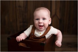baby boy in wooden bucket