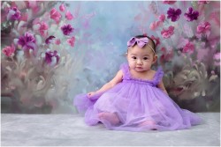 baby girl on floral backdrop