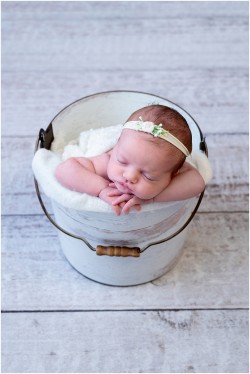 baby girl in white bucket
