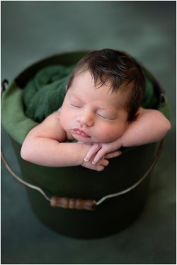 baby boy in green bucket
