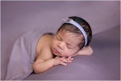 newborn girl on lavender purple blanket