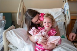 proud big sister meeting newborn